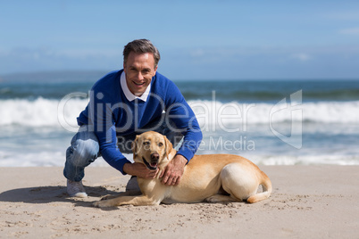Mature man with his dog on the beach