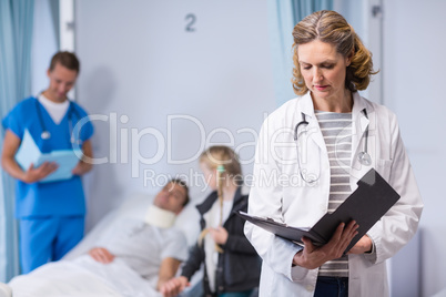Doctor writing on clipboard Doctor writing on clipboard