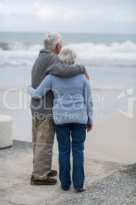 Senior couple standing together on the beach