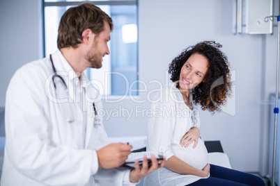 Doctor interacting with pregnant woman