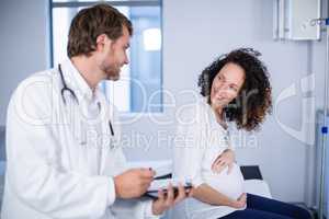 Doctor interacting with pregnant woman