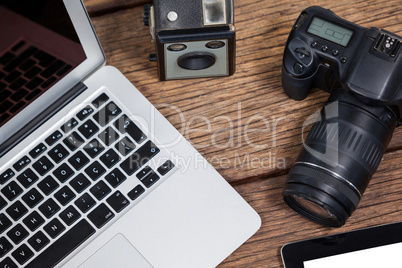 Close-up of laptop with cameras on table