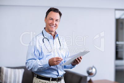 Portrait of male doctor holding clipboard