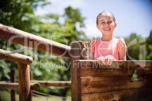 Girl standing and smiling on playground ride in park