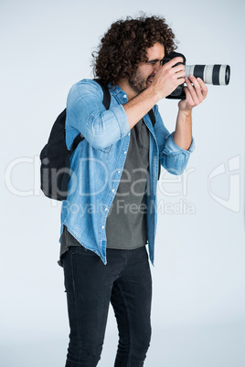 Photographer with digital camera in studio