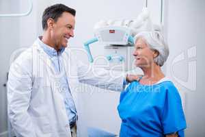 Doctor interacting with senior woman during medical check-up