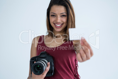 Female photographer showing visiting card in studio