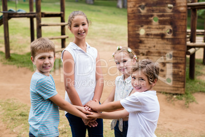 Kids forming hand stack in park