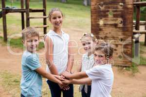 Kids forming hand stack in park