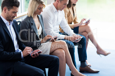 Business executives using mobile phone