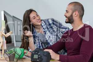 Photographer working at his desk with colleague