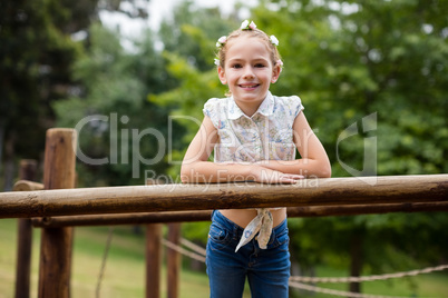 Girl standing on a playground ride in park