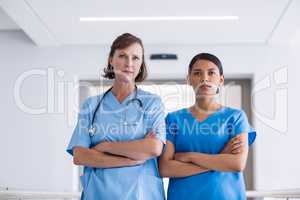 Portrait of nurse and doctor standing with arms crossed