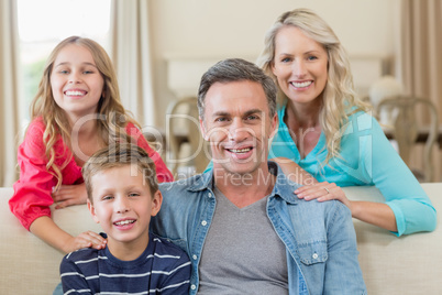 Portrait of smiling parents and kids in living room