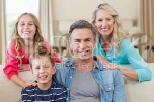 Portrait of smiling parents and kids in living room