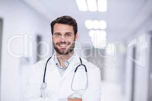 Portrait of male doctor standing with arms crossed