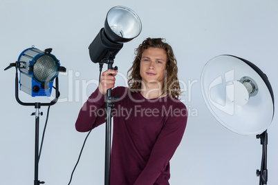 Photographer fixing spotlight