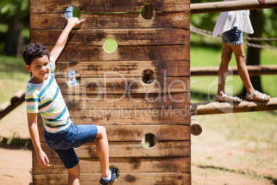 Boy playing on a playground ride in park