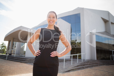 Beautiful and happy businesswoman with hands on hip