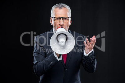 Mature businessman with loudspeaker