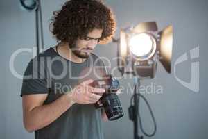 Photographer looking at the photographs in the camera