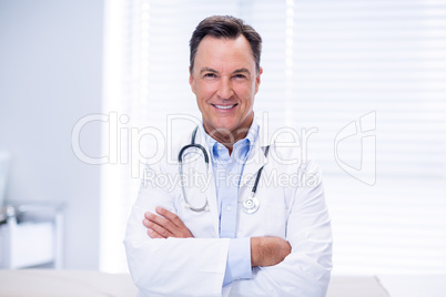 Portrait of male doctor standing with arms crossed