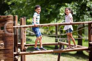 Kids standing on a playground ride in park