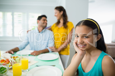 Portrait of girl sitting at dining table