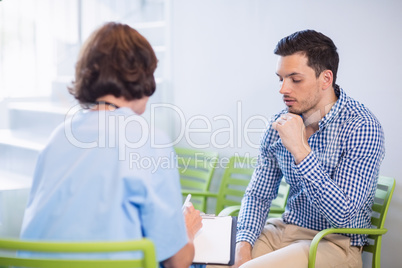 Nurse discussing a medical report with man