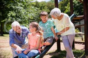 Grandparents playing with their grandchildren in park