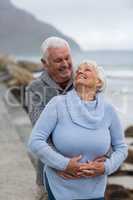 Senior couple embracing each other on the beach