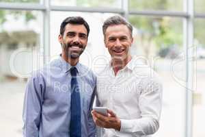 Happy business executives holding a mobile phone