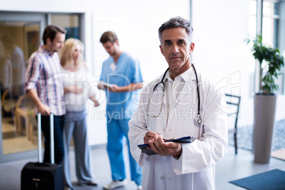 Portrait of smiling doctor holding a clipboard