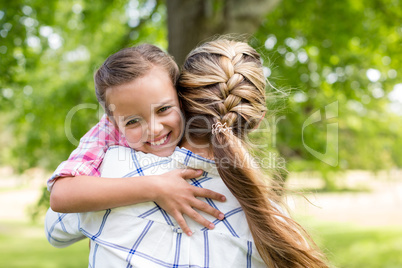 Girl embracing her mother in park