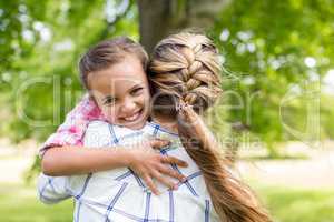 Girl embracing her mother in park