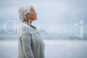 Senior woman standing on the beach