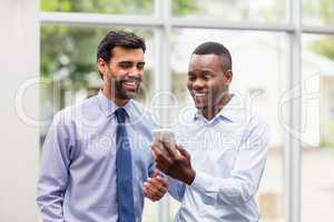 Business executives discussing over mobile phone