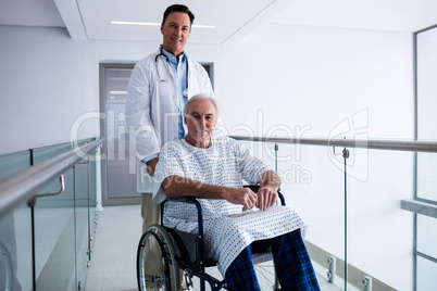 Portrait of doctor smiling with male senior patient on a wheelchair