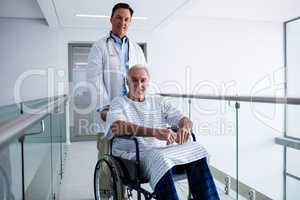 Portrait of doctor smiling with male senior patient on a wheelchair