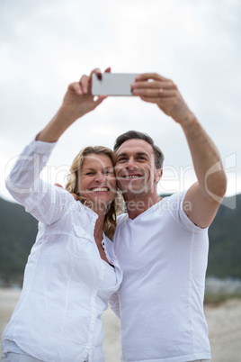 Mature couple taking selfie using mobile phone