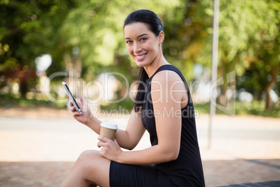 Happy businesswoman holding mobile phone