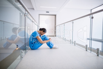 Rear view of nurse standing with hands on hip