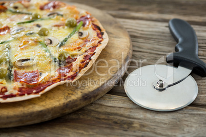 Close-up of italian pizza with pizza cutter on a tray