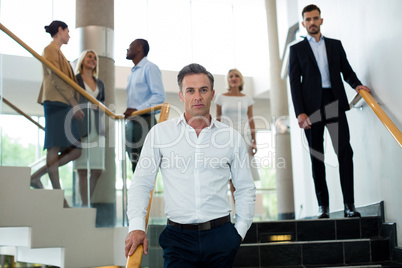 Business executives walking down the stairs