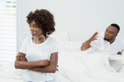 Couple ignoring each other in bedroom