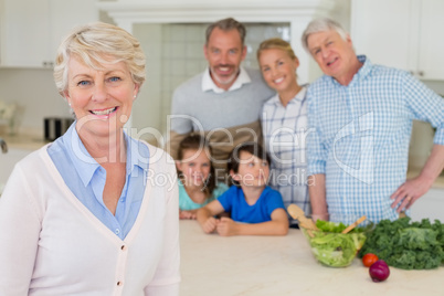 Portrait of happy family standing in kitchen