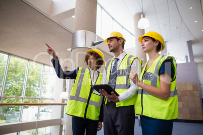 Architects discussing over digital tablet