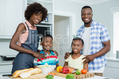 Parents and Kids standing in kitchen at home