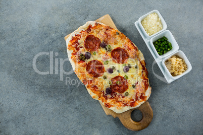 Italian pizza served with ingredients on a chopping board