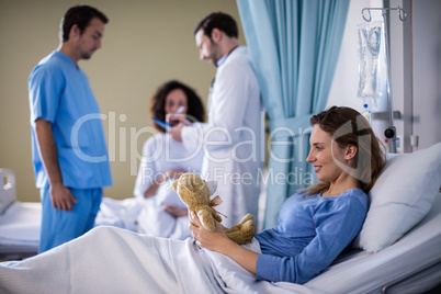 Beautiful woman playing with a teddy bear